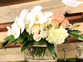 Peach roses with white orchids